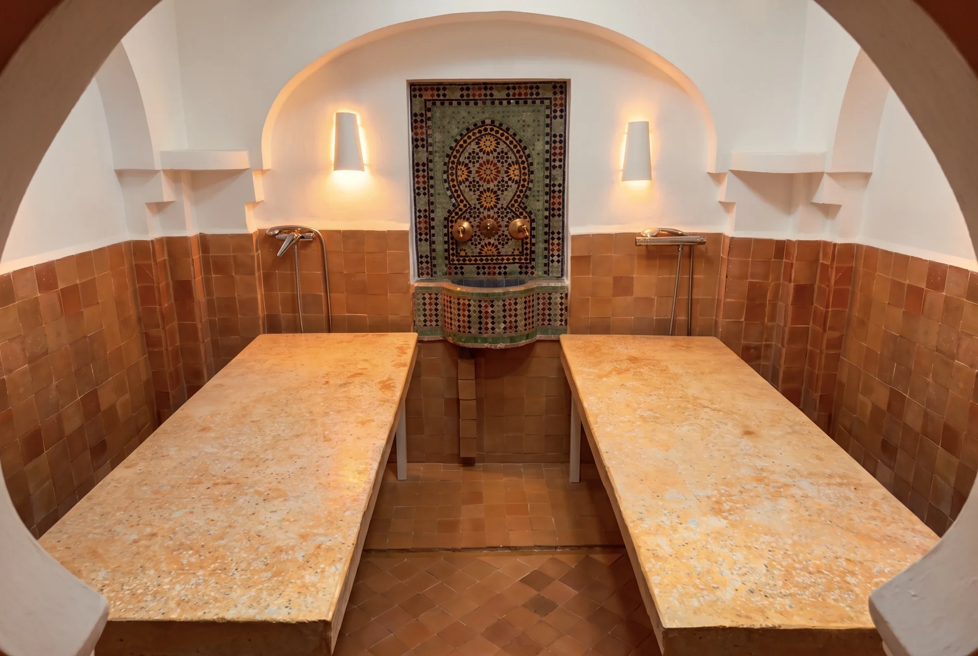 Sala con dos camas de piedra y una fuente de azulejos al fondo