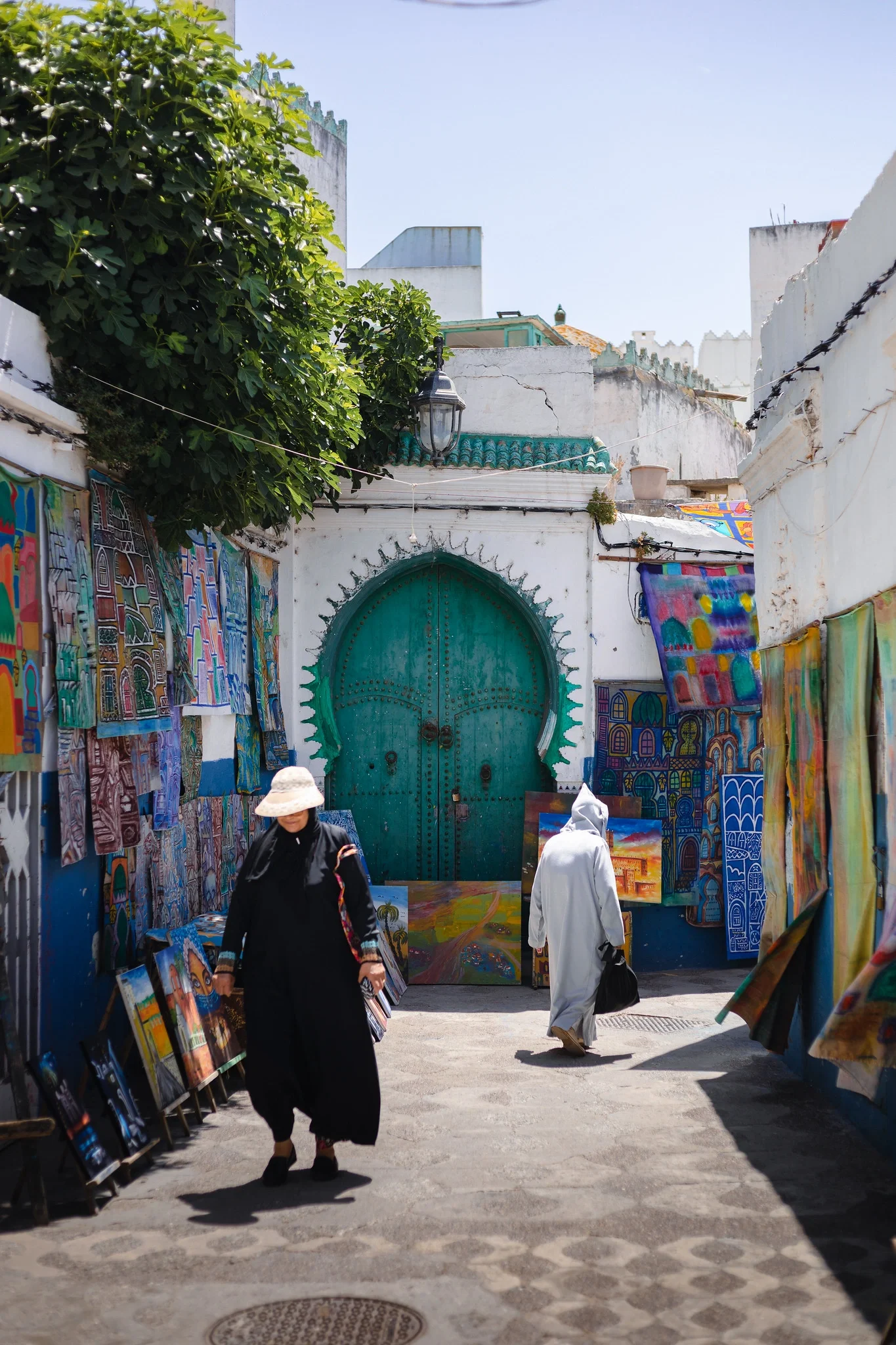 Street in the Asilah medina with paintings on display during the International Cultural Festival
