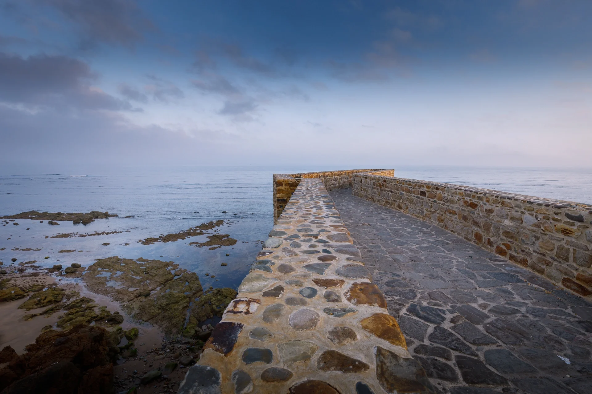 Caraquia Viewpoint (Krikia): a stone breakwater reaching out into the sea
